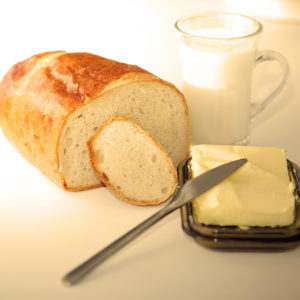 Preparing dinner. A glass of milk, bread, butter